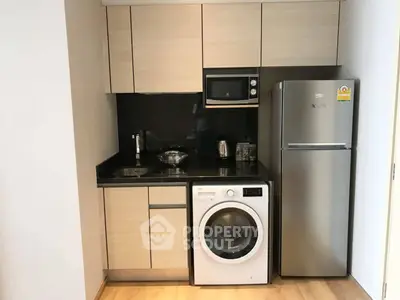 Modern compact kitchen with sleek appliances and wooden cabinetry