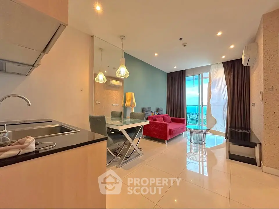 Modern open-plan living room with vibrant decor and balcony view
