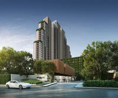 Modern high-rise building with lush greenery and sleek architecture in urban setting.