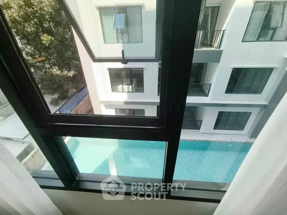 Modern apartment view with pool and balcony, ideal for urban living.