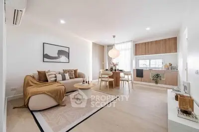 Modern open-plan living room with stylish decor and integrated kitchen area.
