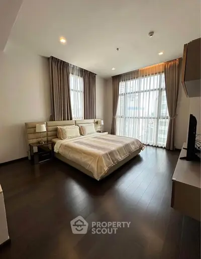Spacious modern bedroom with large windows and elegant decor