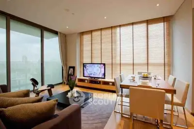 Spacious modern living room with large windows and dining area, perfect for entertaining.