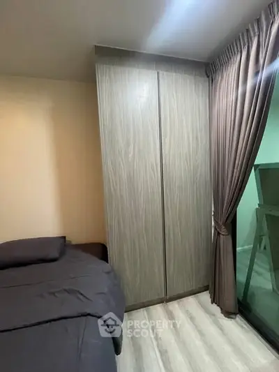 Cozy bedroom with modern wardrobe and large window for natural light