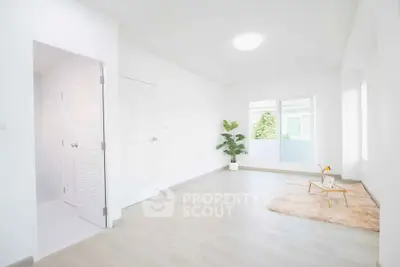 Bright minimalist living room with large window and cozy decor