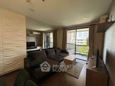 Modern living room with large sofa and balcony view in urban apartment