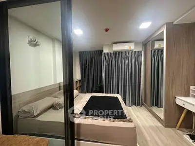 Modern bedroom with sleek design and mirrored wardrobe in stylish apartment.