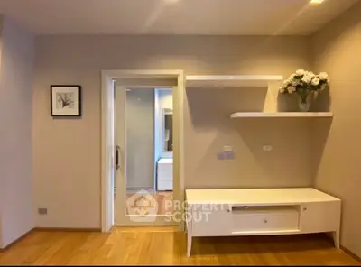 Modern interior with wooden flooring, built-in shelves, and elegant decor