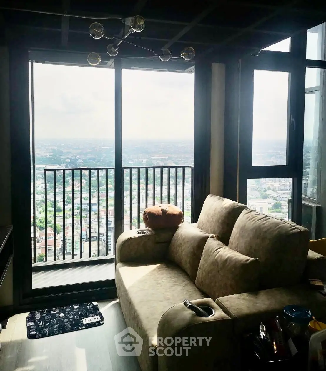 Stunning high-rise living room with panoramic city view and cozy seating area.