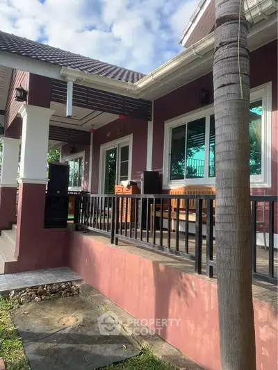 Charming single-story home with spacious porch and lush surroundings, perfect for serene living.