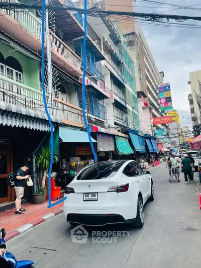 Vibrant street view with colorful buildings and bustling activity, showcasing urban lifestyle and local businesses.