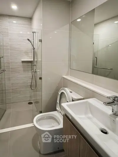Modern bathroom with sleek design, glass shower, and contemporary fixtures.