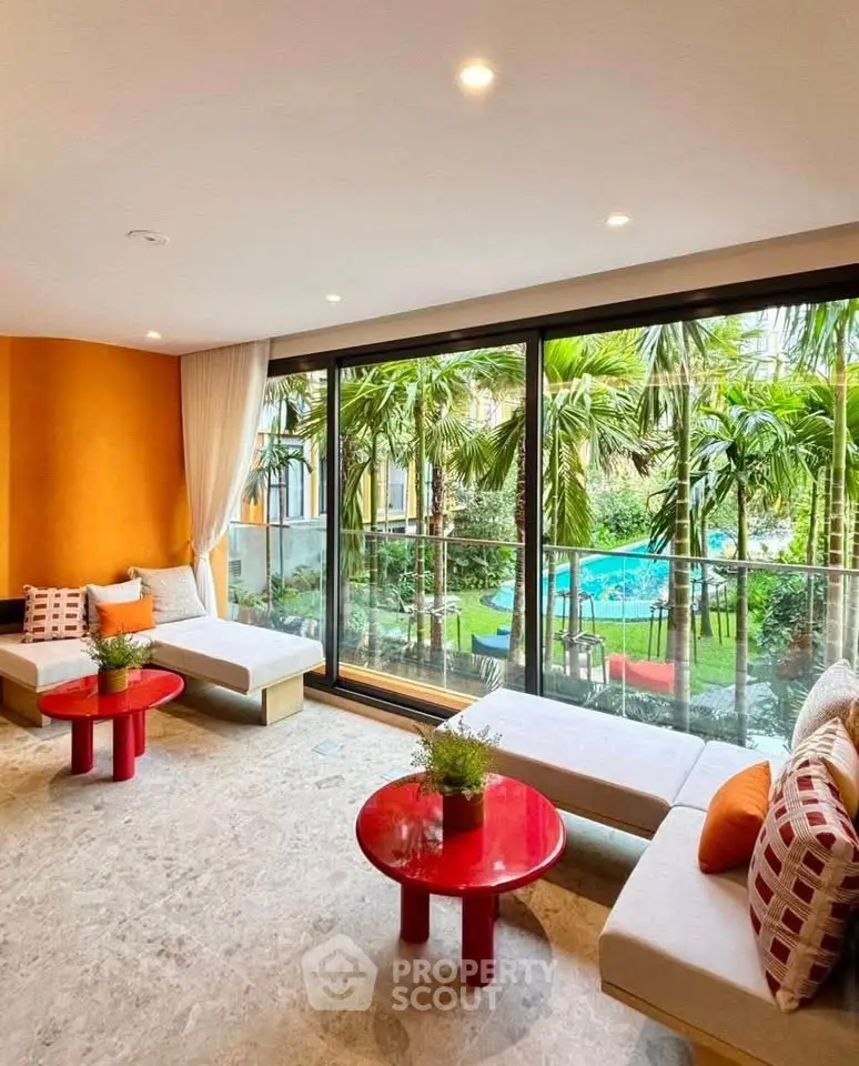 Luxurious living room with pool view and tropical garden, featuring modern decor and vibrant colors.
