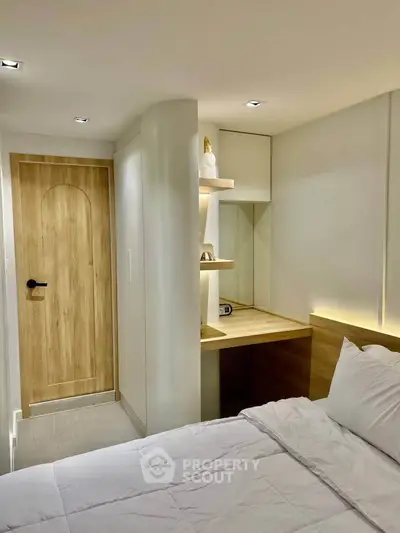 Modern bedroom with cozy study nook and elegant wooden door