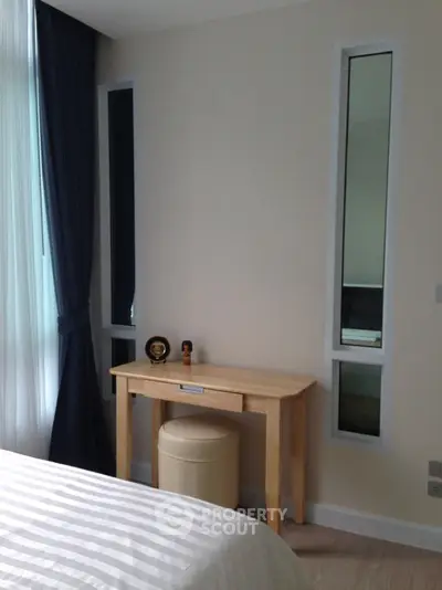 Cozy bedroom corner with natural light and elegant decor