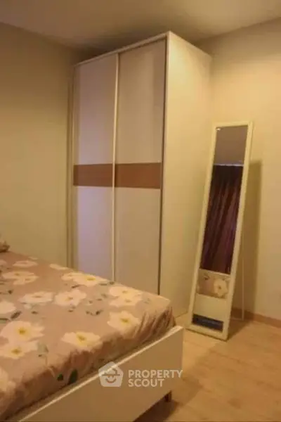 Cozy bedroom with floral bedding and sleek wardrobe design