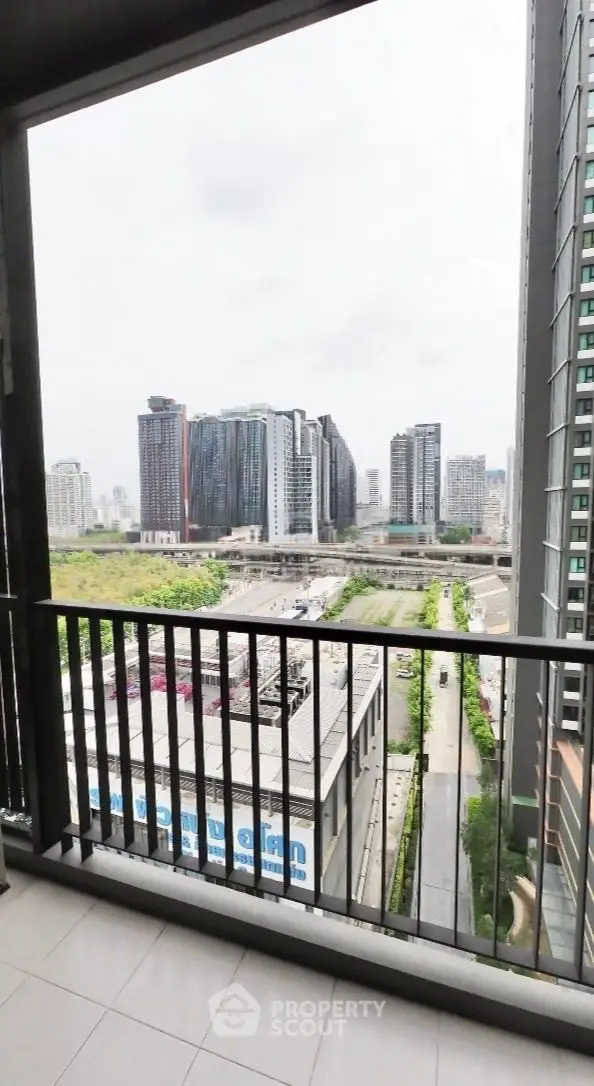 Stunning urban view from a high-rise balcony overlooking modern cityscape.