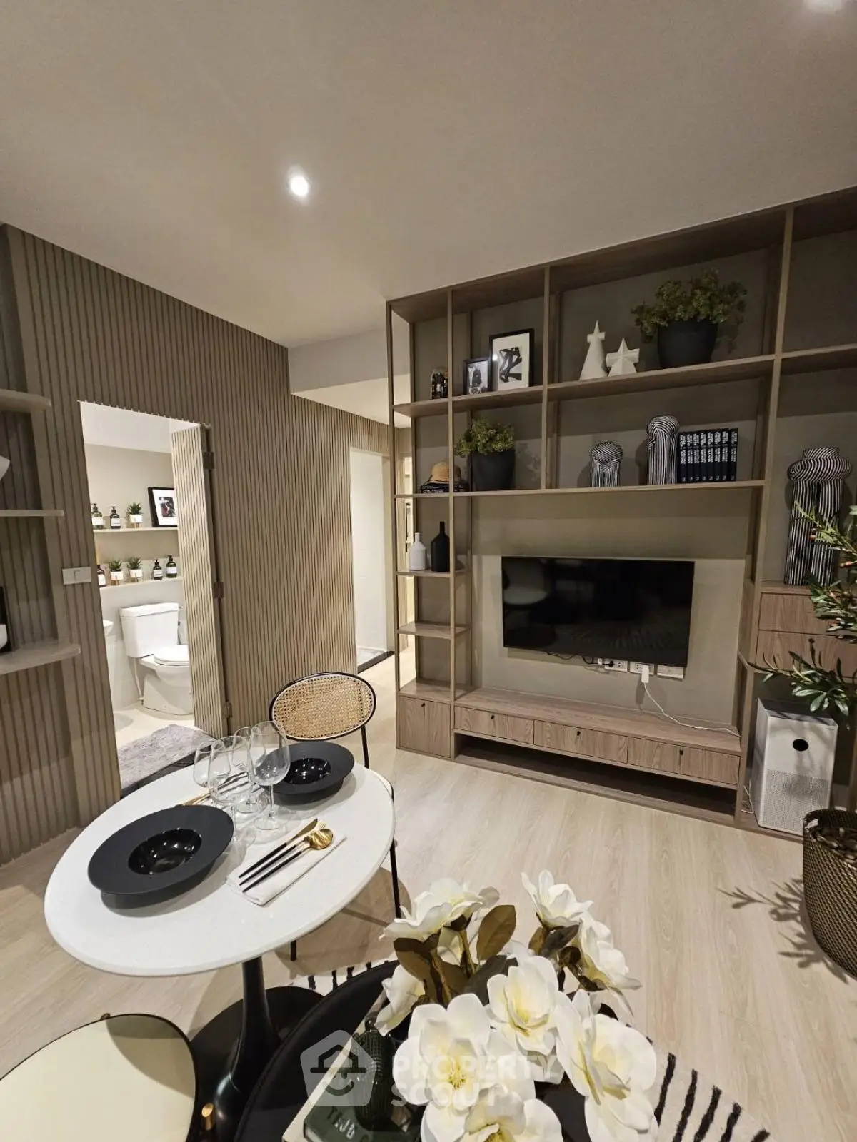 Modern living room with stylish decor and built-in shelving unit