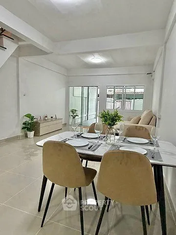 Spacious modern living room with dining area and large windows for natural light.