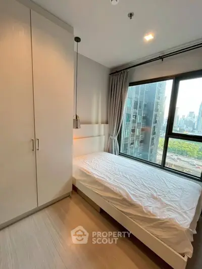 Modern bedroom with city view and ample natural light