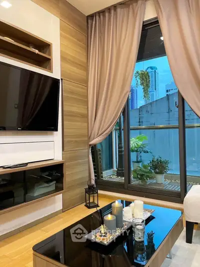 Modern living room with city view, elegant decor, and large window.