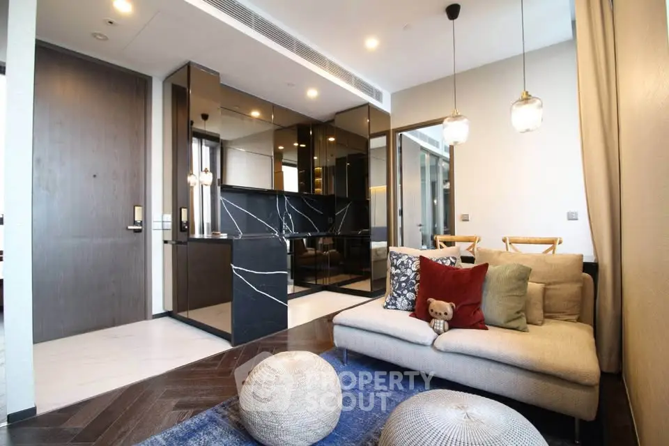 Modern living room with stylish decor and open kitchen layout in luxury apartment.
