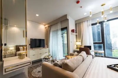 Luxurious modern living room with elegant decor and large windows offering natural light.