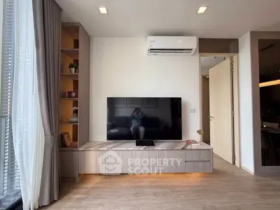 Modern living room with sleek TV setup and stylish wooden flooring