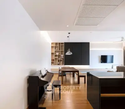 Modern living room with sleek piano and stylish dining area