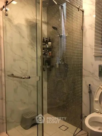 Luxurious bathroom with modern shower and elegant marble tiles