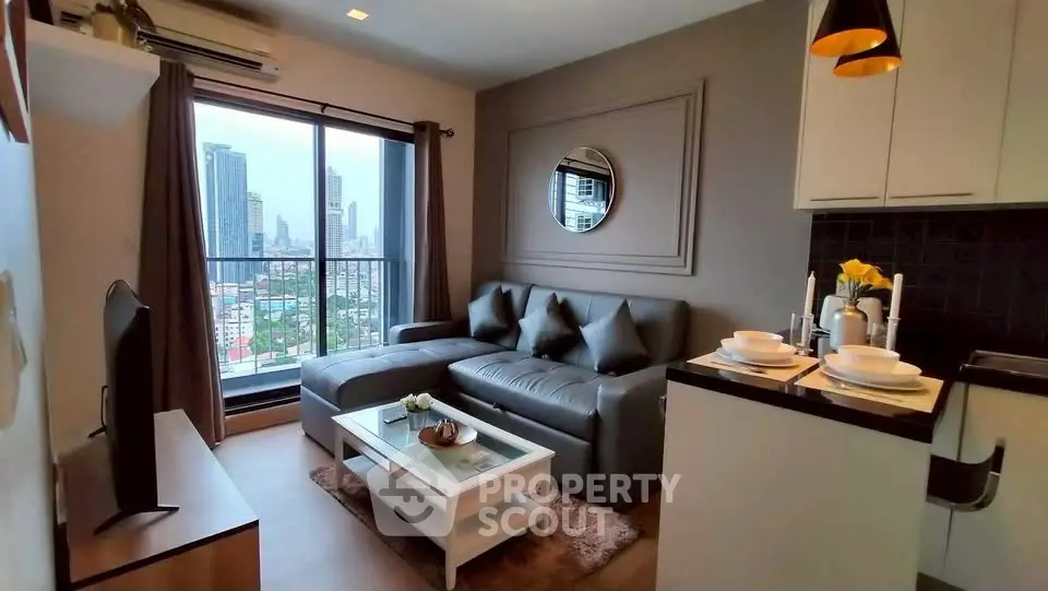 Modern living room with city view, featuring sleek furniture and open kitchen layout.