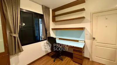 Modern study room with built-in desk and shelves, featuring elegant wood finishes and natural light.