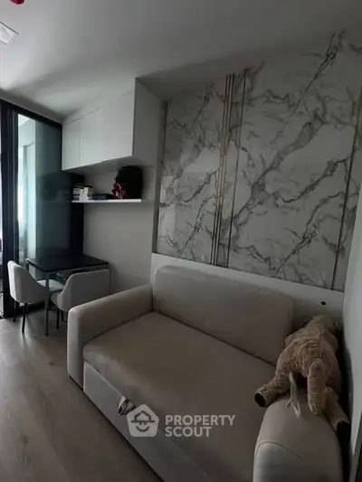 Modern living room with stylish marble accent wall and cozy sofa