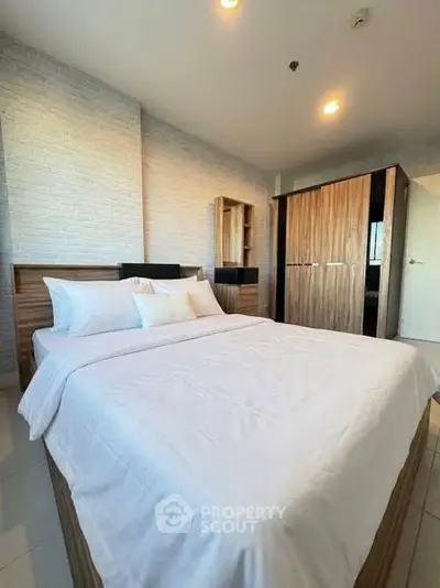 Spacious bedroom with modern wooden furniture and cozy bedding in a stylish apartment.