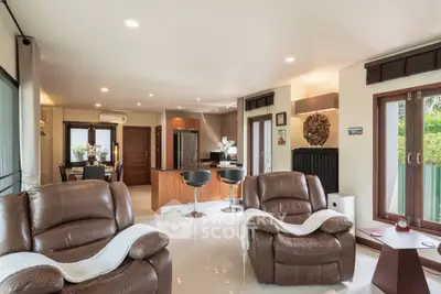 Spacious living room with modern open kitchen and cozy seating area