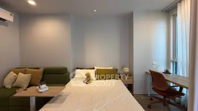 Cozy bedroom with modern decor, featuring a comfortable bed, stylish desk, and ample natural light.