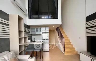 Modern loft apartment with open kitchen and stylish staircase