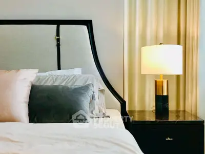 Elegant bedroom with stylish headboard and cozy bedside lamp