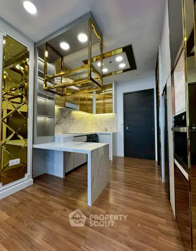 Luxurious modern kitchen with marble countertops and elegant gold accents.