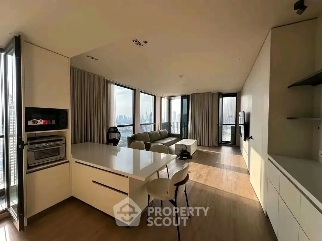 Spacious modern living room with open kitchen and stunning city view