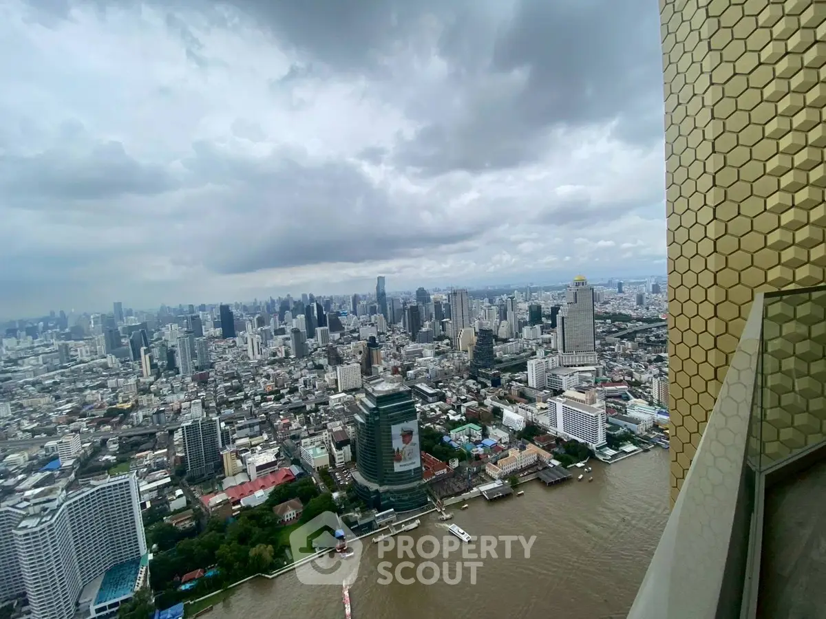 Stunning cityscape view from a high-rise building overlooking a river and urban skyline.