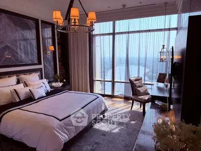 Luxurious bedroom with stunning city view, elegant decor, and natural light.