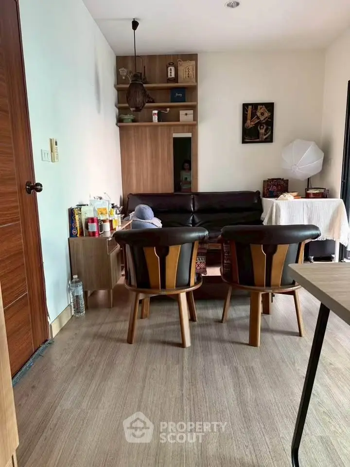 Cozy living room with stylish chairs and wooden flooring, perfect for relaxation.