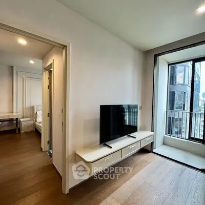 Modern apartment with sleek TV setup and balcony view