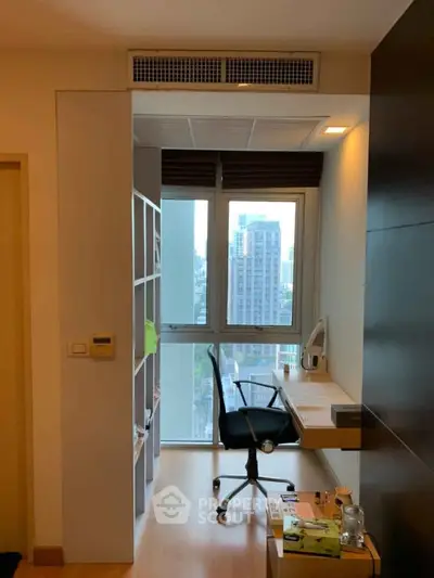 Modern study nook with city view, featuring sleek desk and chair, ideal for productivity.