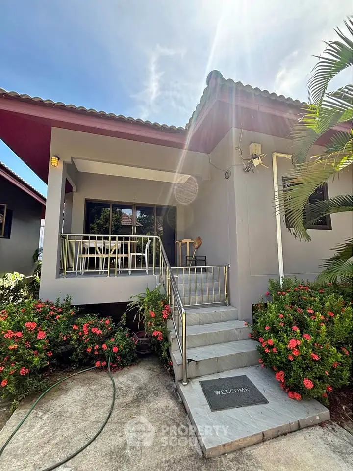 Charming single-story home with inviting entrance and lush garden, perfect for serene living.