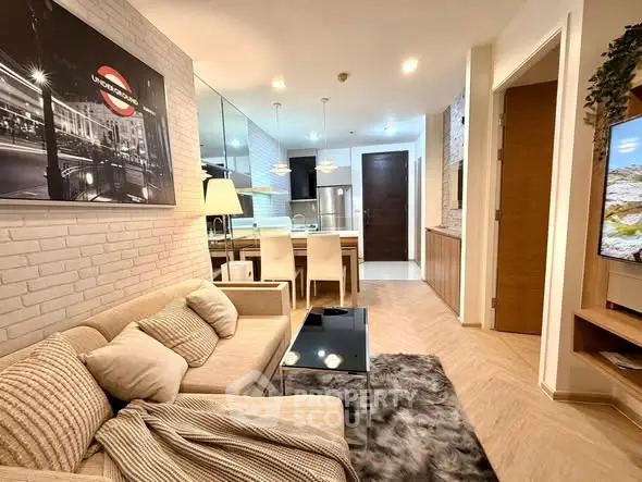 Stylish modern living room with cozy seating and open kitchen layout, perfect for urban living.