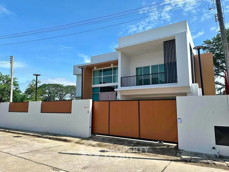Modern two-story house with sleek design and spacious driveway in a serene neighborhood.