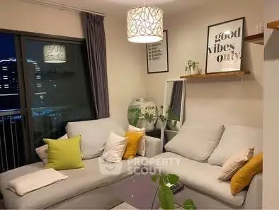 Cozy living room with modern decor and city view, featuring a stylish sofa and ambient lighting.