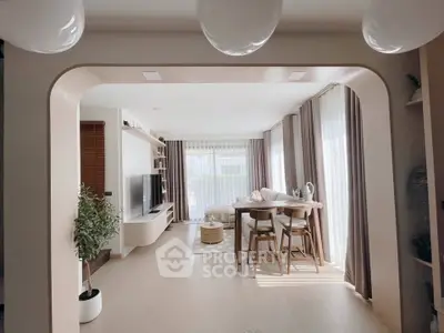 Modern open-plan living and dining area with stylish decor and natural light